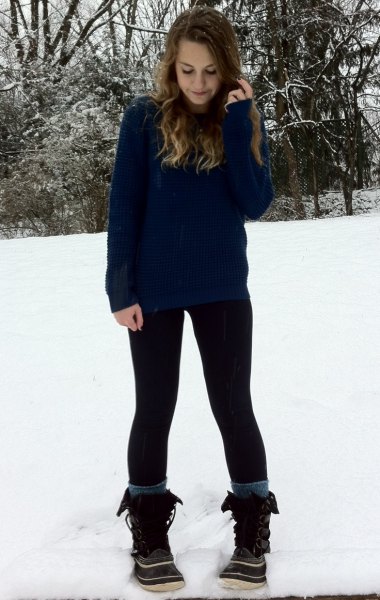 Navy sweater with black leggings and snowshoes