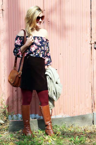 Off-the-shoulder black and white blouse with a floral pattern, black skirt and brown boots