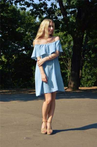 Off-the-shoulder light blue mini-shift denim dress with sandals