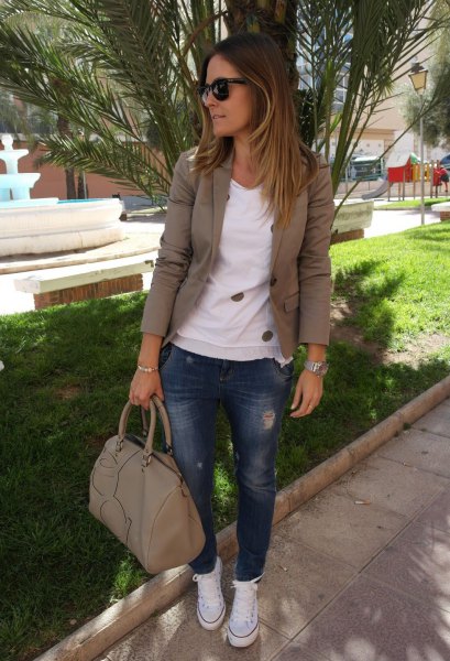 Olive green khaki blazer with a white sweater and blue jeans