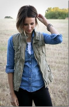 olive green vest with light blue chambray shirt and dark jeans