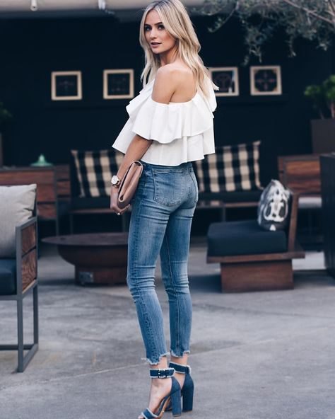 A ruffled shoulder blouse with short skinny jeans and jeans heels