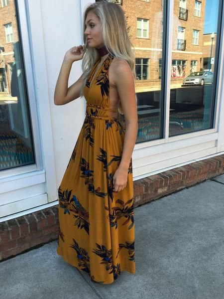 Backless maxi summer dress with a floral pattern in orange and black