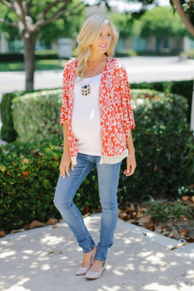 orange and white maternity cardigan with tribal print and blue slim fit jeans