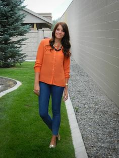 orange shirt with buttons, blue slim fit jeans and metallic shoes