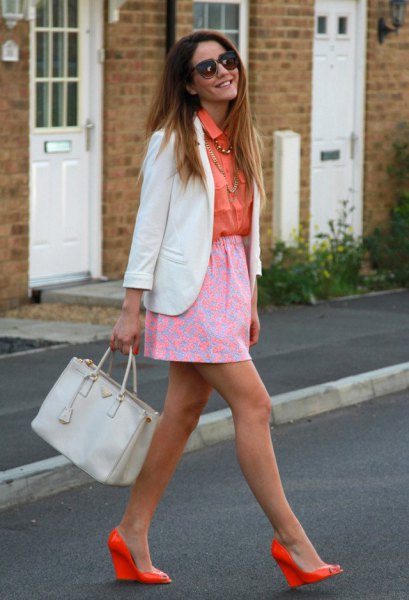 orange shirt with buttons, light pink printed skirt and orange heels
