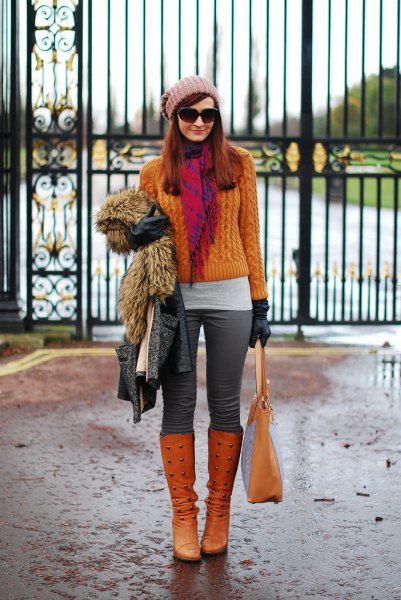 orange cable knit sweater with matching knee-high boots