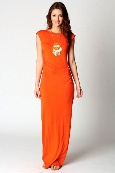 Orange dress with cap sleeves and a statement chain in a boho style