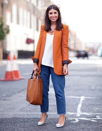 Orange long blazer with a white vest top and wide cut mom jeans