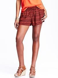 orange top with green mini-shorts with tribal print