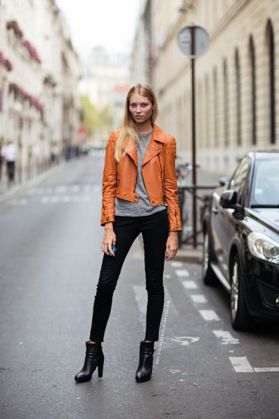 orange-brown leather jacket with gray t-shirt and black jeans