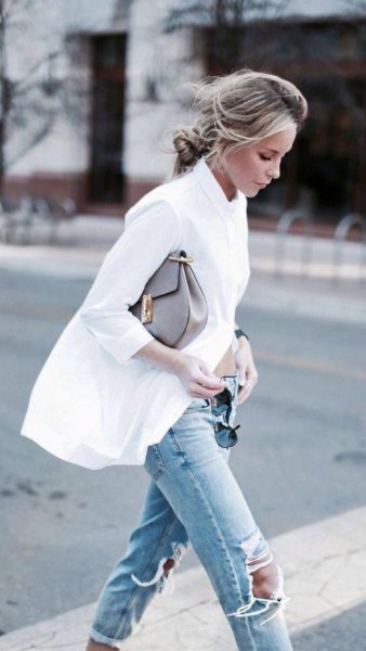 oversized white shirt with buttons and ripped light blue knee jeans