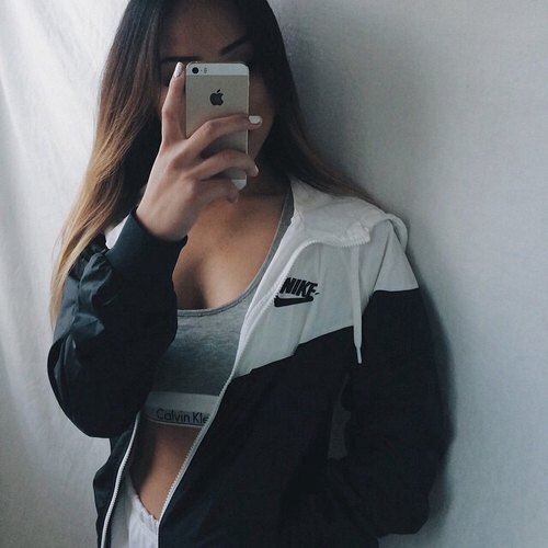 Oversized windbreaker with a gray bra top and white running shorts