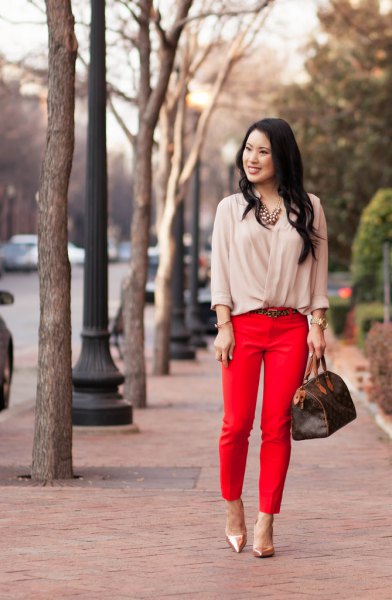Light pink blouse with red, short cut trousers and rose gold heels