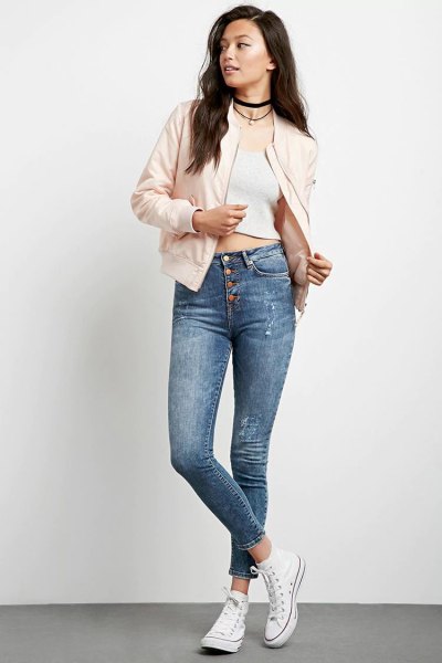 Light pink bomber jacket with a short white tank top