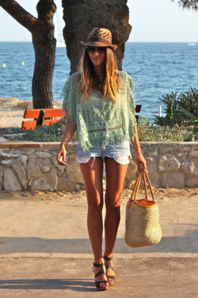Light pink crochet top with mini denim shorts and a beach straw sack
