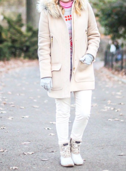 pale pink long coat with a faux fur collar, skinny jeans and white duck boots