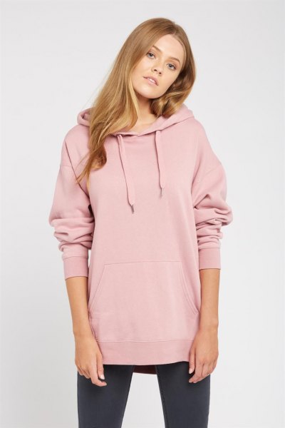 Light pink hoodie with a long cowl neckline, black leggings and sneakers