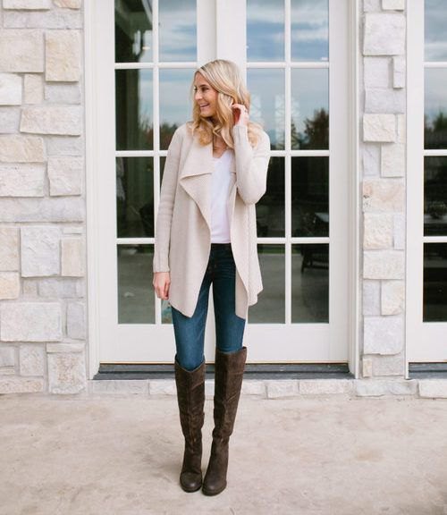 light pink long waterfall cardigan with white tank top and black knee-high boots