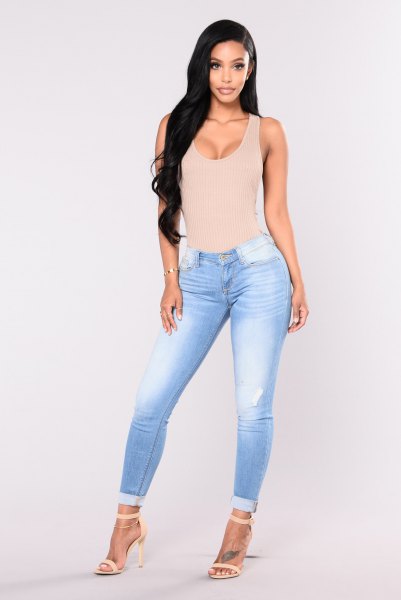 Light pink, low cut, figure-hugging tank top with sky blue, flat skinny jeans