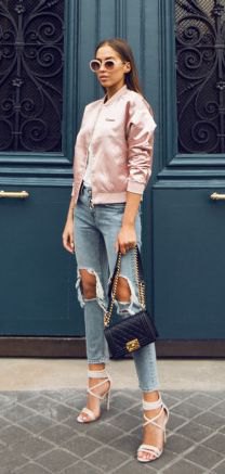 Light pink satin bomber jacket with heavily ripped, short cut jeans