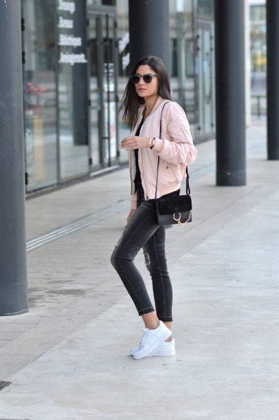 Light pink short bomber jacket with black skinny jeans
