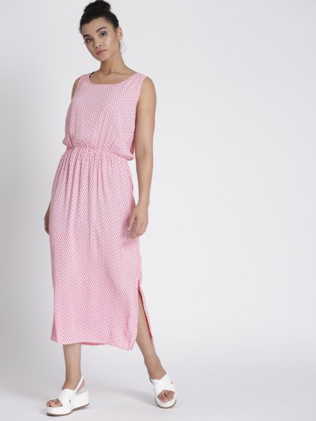 Pale pink sleeveless maxi dress with a gathered waist and white sandals