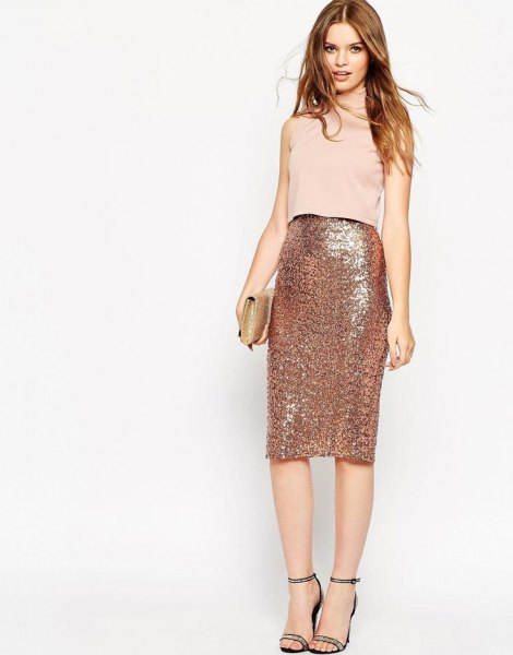 Light pink sleeveless top with a high-waisted midi skirt in rose gold