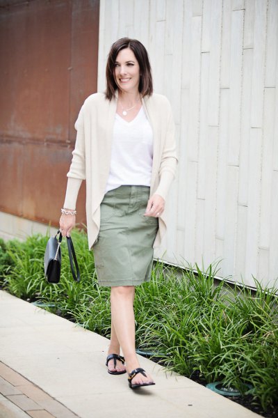 Light pink cardigan with a white V-neck t-shirt and a knee-length skirt