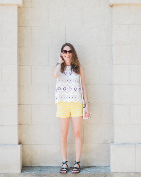 Light yellow shorts with a sleeveless top with white pink and blue scalloped edges