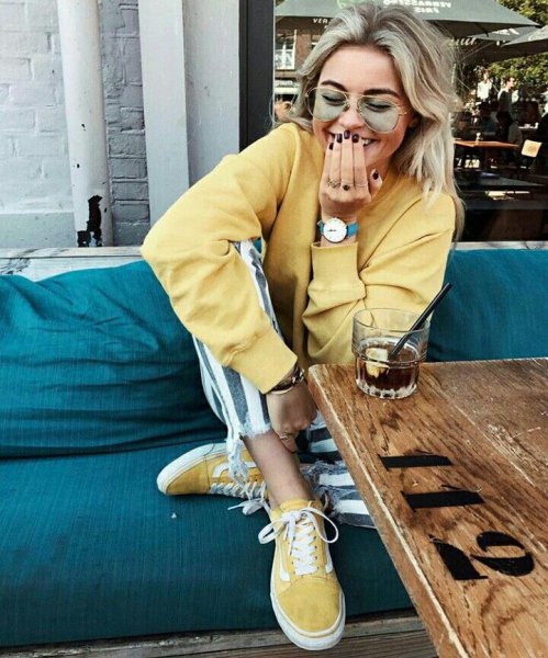 Light yellow sweatshirt with matching canvas sneakers