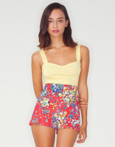 Light yellow tank top with red mini shorts with a floral pattern