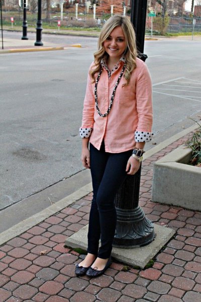peach colored shirt over white and black polka dot blouse