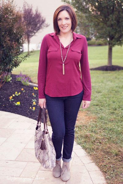pink blouse with dark blue jeans with cuffs and gray suede boots