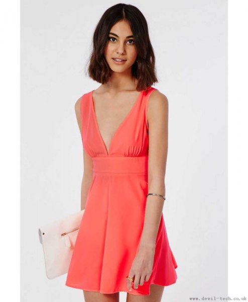 pink mini hangover dress with deep V-neckline and white clutch