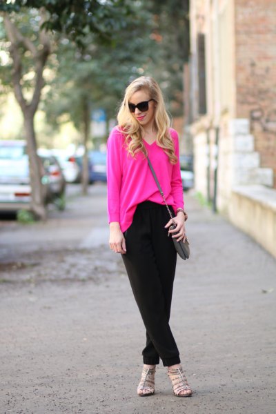 pink V-neck sweater and black chinos