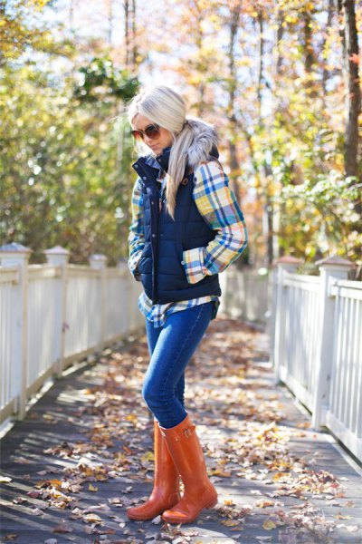 Checkered shirt with a puffer vest and knee-high boots made of orange leather