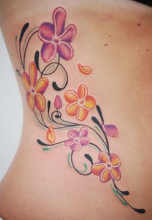 Plumeria tattoo on the side of the body
