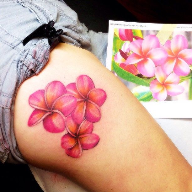 Plumeria tattoo on the thigh
