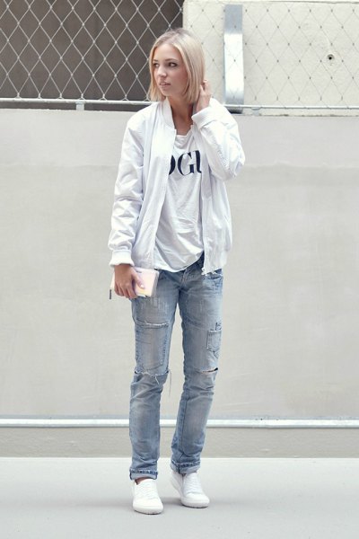 pure white bomber jacket with printed t-shirt and blue straight leg jeans
