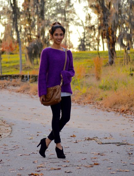 purple sweater with boat neckline and black skinny jeans