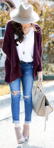 purple chunky zippered cardigan and ripped skinny jeans