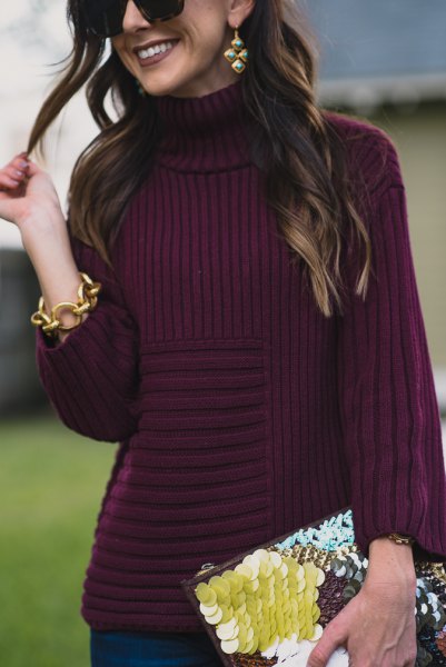 purple turtleneck with turtleneck and black and yellow clutch