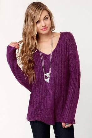 purple knitted sweater with V-neckline and black skinny jeans