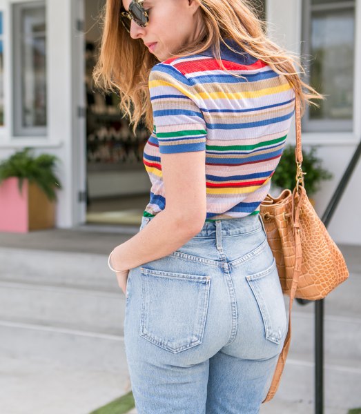 Rainbow colored striped t-shirt with high waisted vintage jeans