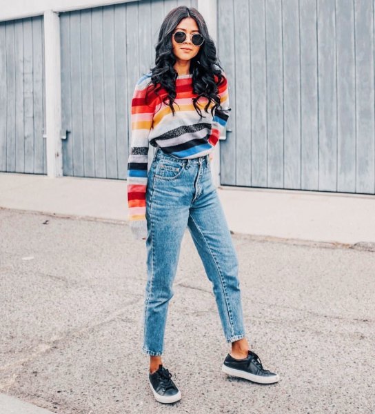 Rainbow-colored striped sweater with cropped mom jeans
