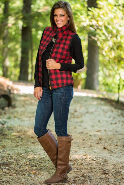 red and black checked vest with mock neck and brown knee-high leather boots