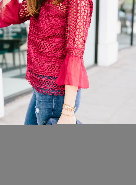 Red crochet lace blouse with bell sleeves and skinny jeans