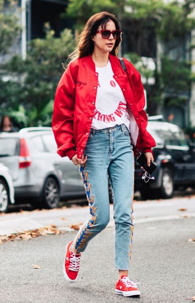 red bomber jacket with white graphic t-shirt and embroidered mom jeans