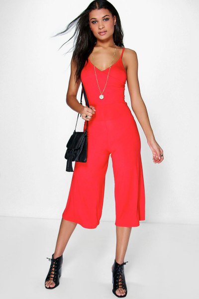 red jumpsuit with deep V-neckline and open toe boots